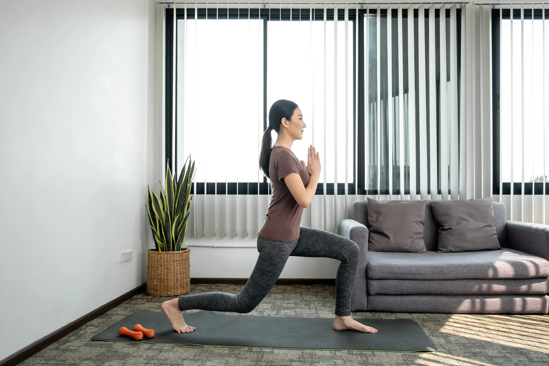 Woman performing stretching and muscle strengthening exercises to improve flexibility, strength and overall fitness